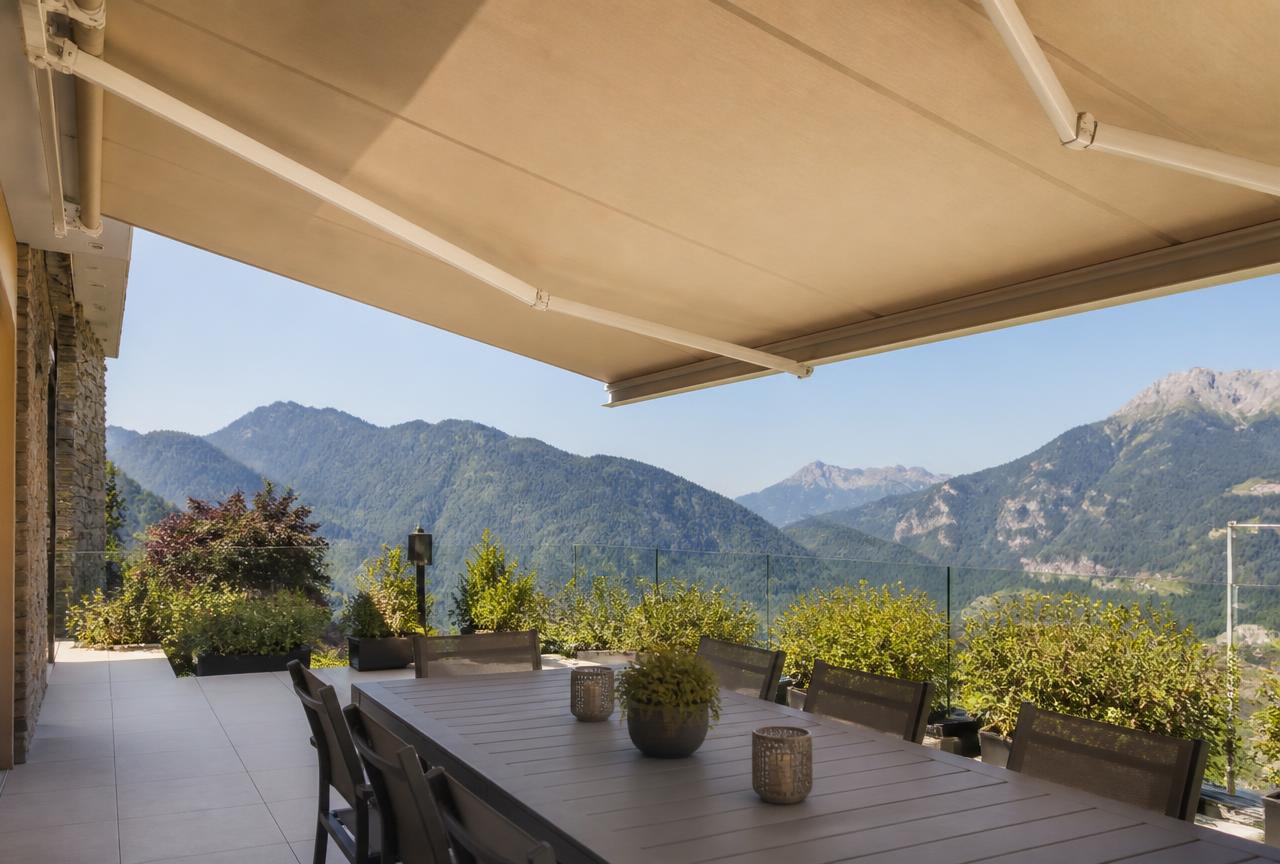 Store banne déployé sur une terrasse avec vue sur les montagnes